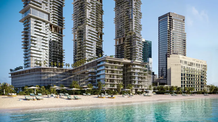 The towers and podium seen from the water, with the private beach in front