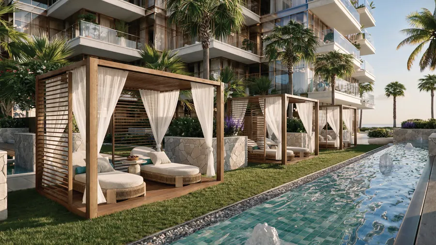 Private cabanas with white drapes beside a long water channel