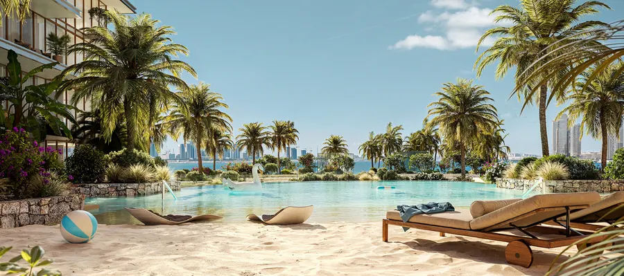 Sandy beach pool with loungers under palm trees