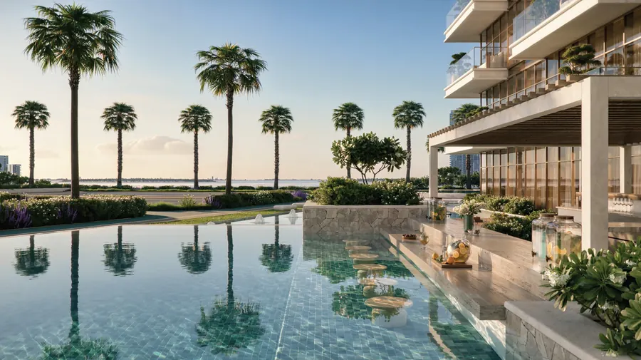 Infinity pool edge with palms and the sea beyond